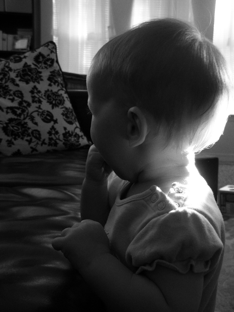 Black and white photo of baby in morning light
